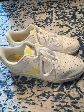 Nike White Leather Sneakers with Yellow Swoosh Accent